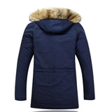 Women's navy blue faux fur hooded insulated water-resistant parka with a fitted waist, long sleeves, and a cozy faux fur-lined collar.