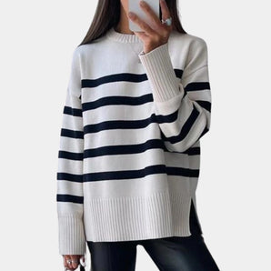 Women's navy blue striped sweater with long sleeves, featuring a casual autumn style, worn by a model.