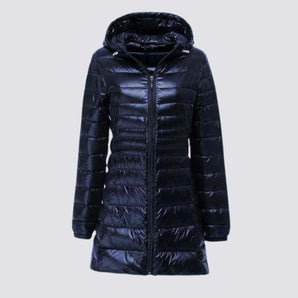 Women's navy long hooded puffer coat in marine blue, featuring a water-resistant insulated design with a fur-trimmed hood, full-length sleeves, and a tailored fit in size 5XL.