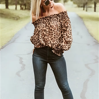 Women's off-shoulder leopard print blouse with long sleeves, styled with blue jeans and sunglasses.