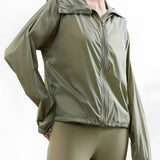 Women's olive green hooded windbreaker, lightweight and breathable with zip-up front, displayed on a mannequin.