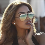 Women's oversized black aviator sunglasses with gradient UV protection, gold frame, one size, worn by a model.