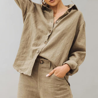 
A woman's oversized black linen blouse featuring a button-down design with a hood, displayed in a khaki color and size 3XL. The blouse has long sleeves and a collared neckline, shown from the shoulder to waist area.
