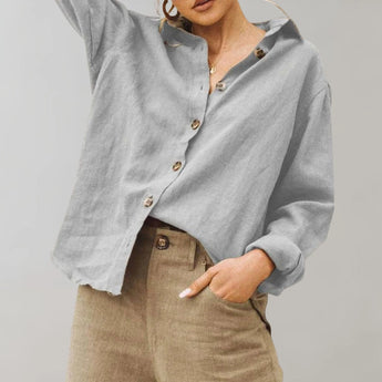 Women's oversized gray linen blouse with button-down design, featuring a hood, long sleeves, and a relaxed fit, styled with a casual, elegant appearance.