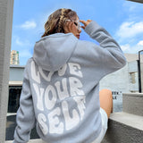 Oversized gray pullover hoodie for women in 2XL, showcasing its long sleeves and comfortable fit. The hoodie is styled for lounging, with a casual and relaxed look.