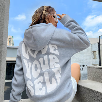 Oversized gray pullover hoodie for women in 2XL, showcasing its long sleeves and comfortable fit. The hoodie is styled for lounging, with a casual and relaxed look.
