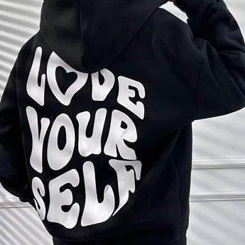 Oversized black pullover hoodie for women, featuring long sleeves and a comfortable fit, ideal for lounging or casual wear.