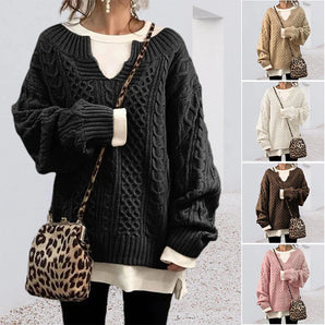 Oversized women's cable knit sweater in a chunky, layered design, featuring long sleeves and a cozy neckline, ideal for winter fashion in black and white tones.