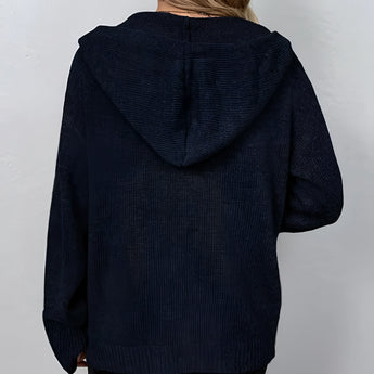 Women's oversized chunky knit cardigan in forest green with button-up front, featuring long sleeves and a woolen texture.