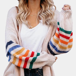 
A women's oversized chunky knit cardigan with multicolor stripes, showcasing its long sleeves and cozy fall design.