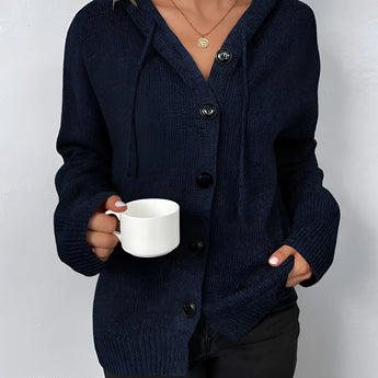 Women's oversized chunky knit cardigan in forest green, featuring a button-up front with long sleeves and a cozy wool texture.