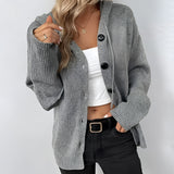 Oversized chunky knit cardigan in gray, featuring a button-up design with long sleeves and a loose fit for a cozy, fashionable look.