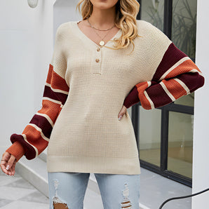 Women's oversized color-block V-neck sweater in beige and rust tones, featuring a stylish and comfortable design with long sleeves and a relaxed fit.