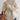 Women's oversized cream turtleneck chunky knit sweater worn by a person, highlighting the long sleeves, textured knit pattern, and high neck design.