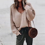 Women's oversized gray V-neck sweater with a relaxed fit, featuring long sleeves and a soft knit texture appropriate for autumn wear. The sweater shown is in a 2XL size and khaki variant, highlighting stylish and comfortable fashion elements.