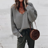 
A women's oversized gray V-neck sweater in a relaxed fit, featuring long sleeves and a cozy knit texture, suitable for autumn wear.