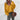 Woman wearing an oversized yellow V-neck sweater with a relaxed fit, featuring long sleeves and a casual autumn knitwear design in a 2XL size.