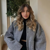 Women's oversized gray wool blend coat with chunky knit design, featuring a fashionable collar and long sleeves, perfect for winter wear.