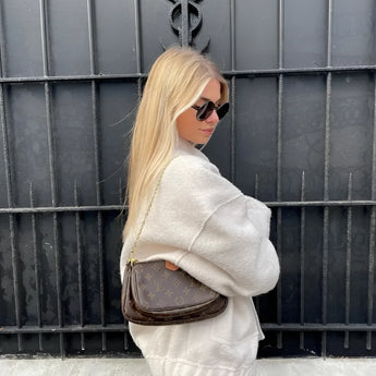 A woman wearing a women's oversized gray wool blend coat with chunky knit texture, showcasing winter fashion. She is accessorized with eyewear and sunglasses, highlighting her face and neck. The coat features long sleeves and a warm, stylish design suitable for cold weather.