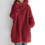
An oversized red zip-up hoodie for women, featuring a relaxed fit with soft fabric. The hoodie includes a collar, long sleeves, and a front zipper.