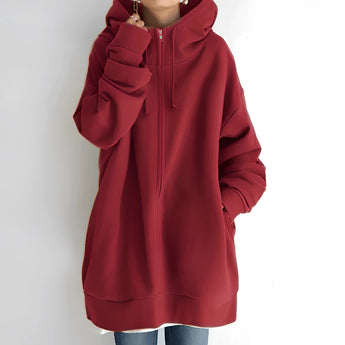 
An oversized red zip-up hoodie for women, featuring a relaxed fit with soft fabric. The hoodie includes a collar, long sleeves, and a front zipper.