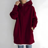 Oversized wine red zip-up hoodie for women in 5XL, featuring a soft fabric and relaxed fit. The hoodie includes long sleeves, a comfortable collar, and is displayed in a standing position.