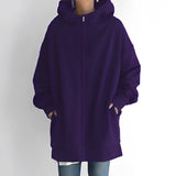 
A women's oversized zip-up hoodie in purple, featuring a relaxed fit. The hoodie is made from soft fabric, with details such as a collar, long sleeves, and a zip front closure. The image highlights the shoulder and neck area, showcasing the comfortable and casual style suitable for sportswear or everyday wear.