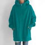 
An oversized green zip-up hoodie designed for women, featuring a relaxed fit. The hoodie is made from soft fabric and includes a full front zipper, long sleeves, and a comfortable collar.
