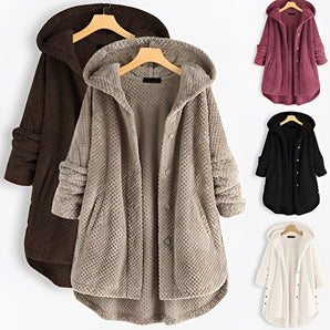 Women's oversized hooded fleece jacket in grey and white with long sleeves and a fashionable collar, made from natural materials, showcased against a neutral background.