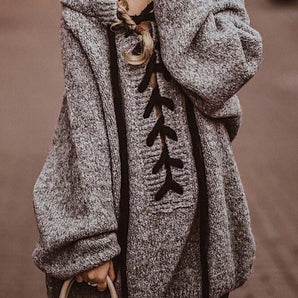 Oversized gray wool coat with toggle buttons, featuring a hood and long sleeves, suitable for winter fashion.