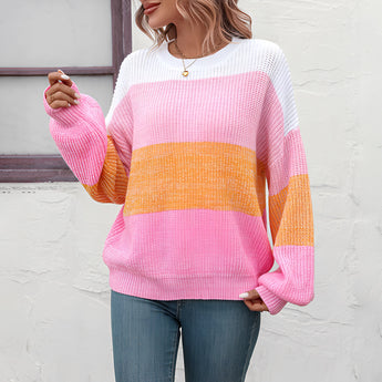 Women's oversized knit sweater with pastel stripes in aqua and purple, featuring long sleeves and a cozy, relaxed fit.