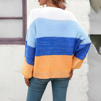 Women's oversized pastel striped knit sweater in aqua and purple, featuring a cozy pullover design.