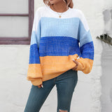 Women's oversized pastel striped knit sweater in aqua and purple, featuring long sleeves and a cozy pullover design.