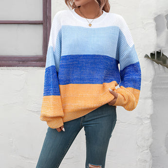 Women's oversized pastel striped knit sweater in aqua and purple, featuring long sleeves and a cozy pullover design.