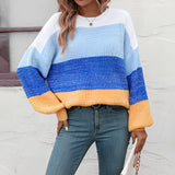 
A women's oversized pastel striped knit sweater featuring cozy aqua and purple colors, styled as a pullover. The sweater is displayed in a dark blue color variant, in size XL, with a focus on its comfortable fit and long sleeves.