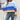 
A women's oversized pastel striped knit sweater featuring cozy aqua and purple colors, styled as a pullover. The sweater is displayed in a dark blue color variant, in size XL, with a focus on its comfortable fit and long sleeves.