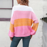 
A cozy women's oversized knit sweater featuring pastel aqua and purple stripes, showcasing a relaxed fit with long sleeves and a round neckline.