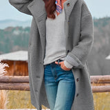 Women's oversized gray wool winter coat with chunky buttons, featuring a stylish collar and long sleeves, ideal for standing out in cold weather.