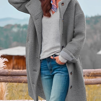 Women's oversized gray wool winter coat with chunky buttons, featuring a stylish collar and long sleeves, ideal for standing out in cold weather.