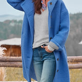 
A woman wearing an oversized pink wool winter coat with chunky buttons, modeled in a casual standing pose.