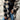 Women's oversized plaid fleece shacket featuring a monogram "M" design, shown in a black tartan pattern, size 2XL. The cozy winter outerwear is modeled with focus on the shoulder and sleeve, presenting a stylish and fashionable look.