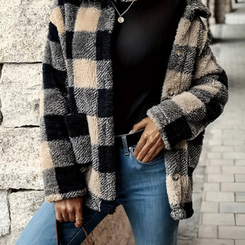 Women's oversized plaid fleece shacket featuring a monogram "M" design, shown in a black tartan pattern, size 2XL. The cozy winter outerwear is modeled with focus on the shoulder and sleeve, presenting a stylish and fashionable look.