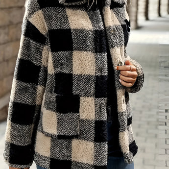 Women's oversized plaid fleece shacket in a cozy winter style with a monogram "M," featuring a black, white, and grey tartan pattern.