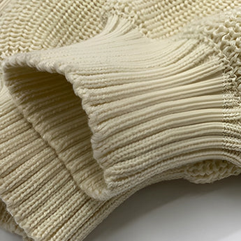 Oversized red stripe off-shoulder sweater for women displayed on a wooden floor, showcasing its autumn fashion style with woolen fabric and pattern details.