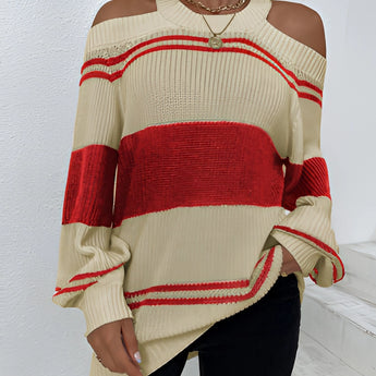 
A woman wearing an oversized red stripe off-shoulder sweater, showcasing autumn fashion with long sleeves and a relaxed fit.