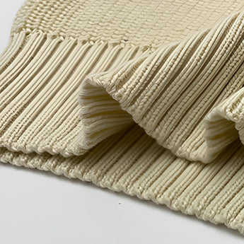 
A women's oversized red stripe off-shoulder sweater laid on a wooden surface, showcasing its long sleeves and cozy wool texture, ideal for autumn fashion.