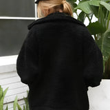 Oversized red teddy coat worn by a woman, showcasing a warm and plush texture ideal for winter, with visible collar and sleeves.