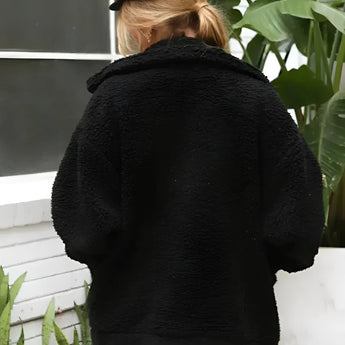 Oversized red teddy coat worn by a woman, showcasing a warm and plush texture ideal for winter, with visible collar and sleeves.