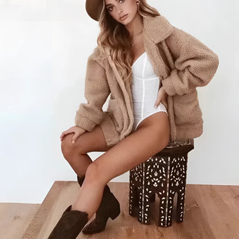 Women's oversized red teddy coat, featuring a warm plush texture, long sleeves, and a cozy design ideal for winter weather.