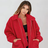 Women's oversized red teddy coat with plush texture, featuring a wide collar and long sleeves, designed for warmth in winter.